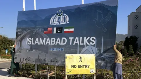 EPA A large, blue road-side sign which reads: Islamabad Talks, April 2026. 