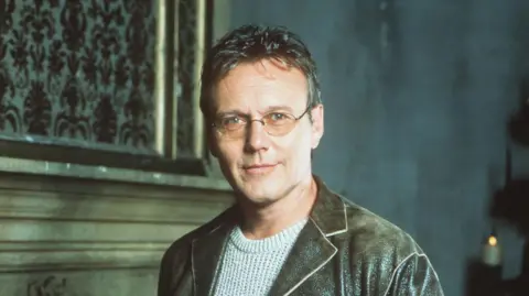 Online USA Anthony Head poses for a photo in character as Rupert Giles from Buffy the Vampire Slayer 
