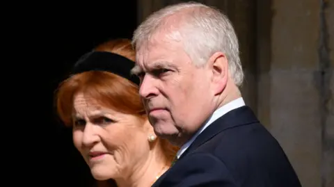 Getty Images A picture of Sarah Ferguson in a black headband, and Andrew in a dark suit