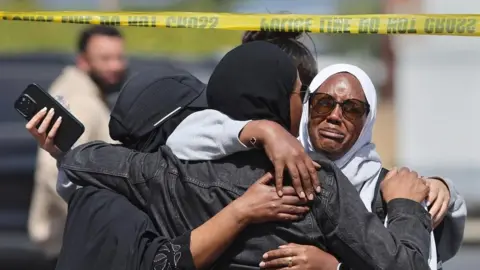 EPA Members of the Muslim community in San Diego react after shooting at their mosque on 18 May 2026