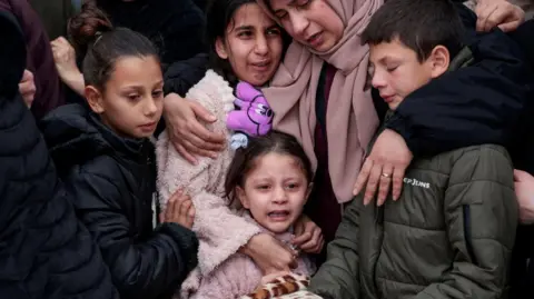 Reuters A woman has her arms around children, comforting them as they mourn the deaths of members of a Palestinian family in Tammoun, occupied West Bank. 