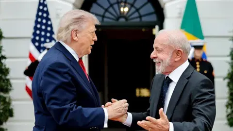 Getty Images US President Donald Trump and Brazil President Luiz Inácio Lula da Silva greet each other at the White House in Washington on Thursday in this handout photo from the Brazilian government.
