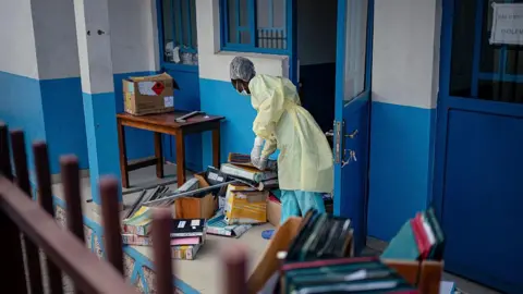 Getty Images Staff members at CBCA Virunga Hospital prepare rooms intended for possible suspected Ebola cases following official announcements in Goma