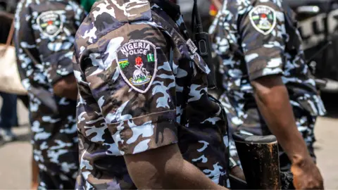 AFP via Getty Images Nigerian police officers in camouflage uniform