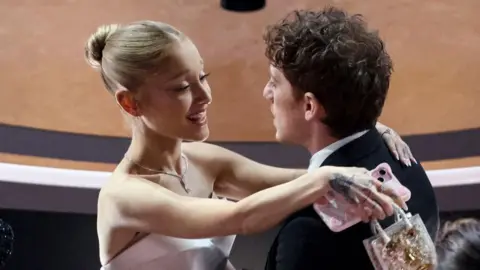 Getty Images Ariana Grande embarces Ethan Slater at the Oscars ceremony last year