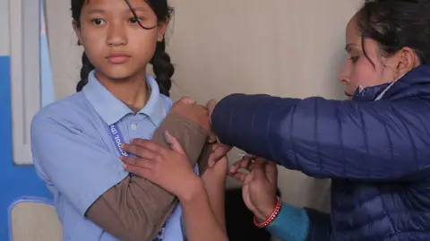 Getty Images In Kathmandu, Nepal, on February 10, 2026, a Nepalese student receives a dose of the Human Papillomavirus (HPV) vaccine at a local school as part of a government vaccination campaign