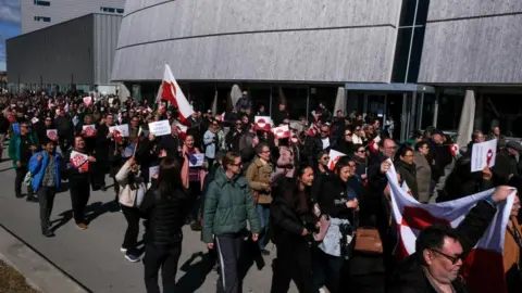 Reuters People gather to protest on the day of the opening of a new U.S. consulate in Nuuk, Greenland, May 21, 2026. REUTERS/Tim Barsoe