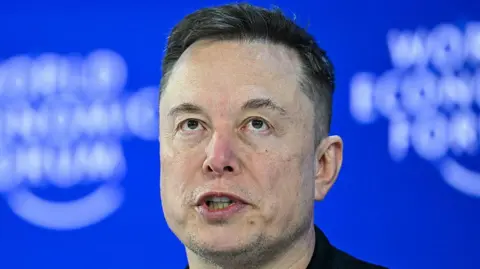 AFP via Getty Images A head shot of CEO of SpaceX and Tesla, South African-Canadian-US businessman Elon Musk, with a blue background