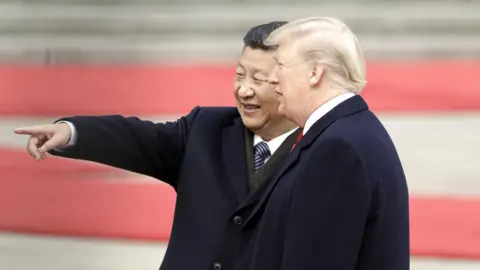 Getty Images Xi Jinping, China's president, left, gestures while standing next to U.S. President Donald Trump, during a welcome ceremony outside the Great Hall of the People in Beijing, China, in November 2017.