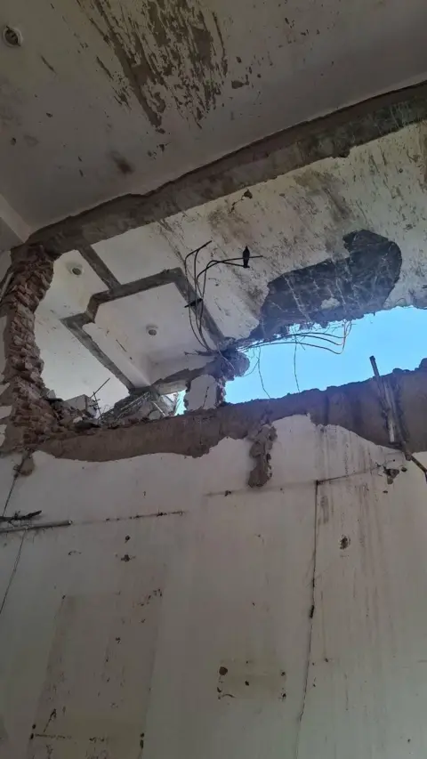 Aditya Dayal A hole in the ceiling of the hostel mess where the plane struck 