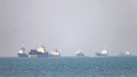 Reuters Six ships of varying types and sizes pictured on a bright day in the open sea, in the Strait of Hormuz near the Iranian port of Bandar Abbas