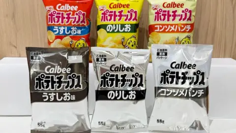 Calbee Shelves lined with packs of Calbee crisps, including the company's new black-and-white packaging.