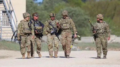Getty Images US troops walking with guns during a training exercise in Germany