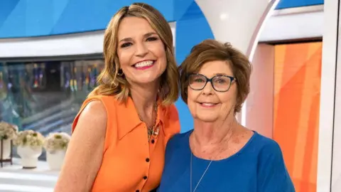Reuters Nancy Guthrie, the 84-year-old mother of U.S. journalist and television host Savannah Guthrie, poses with Savannah in an undated photograph.