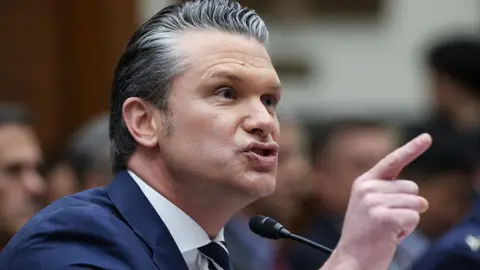 Getty Images A close photo of Pete Hegseth pointing his finger and speaking into a mic at a congressional hearing