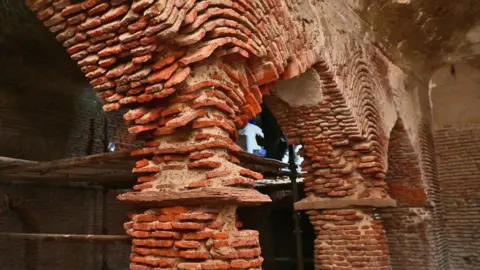 ASI The dilapidated structure of the Shahi Bawarchikhana inside Chota Imambara before conservation work began, with exposed lakhauri brick walls visible.