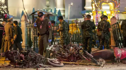 Reuters Experts investigate at the site of a blast in central Bangkok