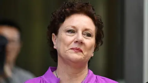 Reuters Kathleen Folbigg wearing a purple shirt. She has short curly brown hair.