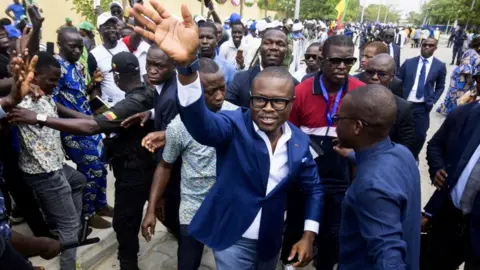 Reuters Romuald Wadagni, Benin's finance minister and the ruling party candidate for the presidential election, waves after presenting his platform in Cotonou, Benin March 21, 2026