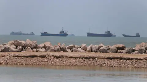 ISNA/WANA/Reuters Ships in the distance on the coast line near Iran.