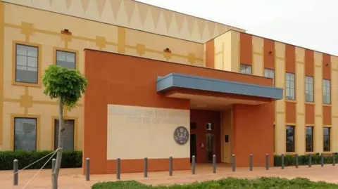 US embassy/ Facebook A front view of the US embassy in Ouagadougou. It is coloured brown and yellow