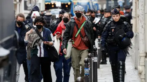 Reuters Protesters in support of Palestinians in Gaza are escorted away by police forces during the evacuation of the Sciences Po University in Paris, 3 May 2024