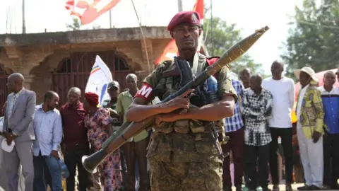 Reuters A member of the Armed Forces of the Democratic Republic of the Congo (FARDC) stands guard along a street after retaking control of multiple localities in the Ruzizi Plains, following the withdrawal of M23 rebels from Uvira territory, in Sange, South Kivu province of the Democratic Republic of Congo May 12, 2026
