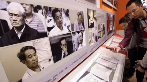 Getty Images Visitors read the statements of repentance written by some of the fallen top corrupted officials, while the pictures of six highest ranking corrupted officials are displayed, (from upper left to right) Zhou Yongkang, Bo Xilai, Guo Boxing, Xu Caihou, Sun Zhengcai, and Ling Jihua