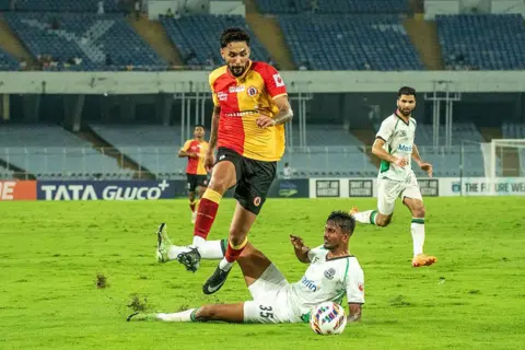NurPhoto via Getty Images EBFC's Brazilian footballer Miguel Figueira moves past an MSC defender during the match between East Bengal FC and Mohammedan Sporting Club on matchweek 6, on March 23, 2026, at Salt Lake Stadium, Kolkata, India