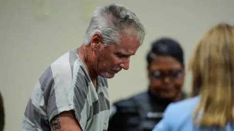 Getty Images The father in a prison jumpsuit