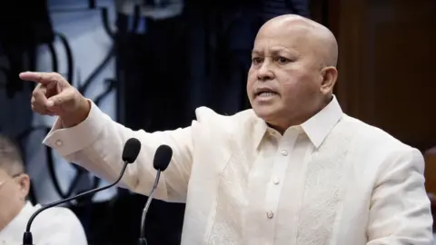 EPA Philippine senator Ronald Bato Dela Rosa speaks from a podium on the Senate floor