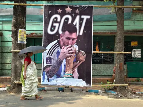 NurPhoto via Getty Images A woman passes by a large hoarding of Lionel Messi ahead of the FIFA World Cup 2026 in Kolkata, India, on June 9, 2026. (Photo by Sudipta Das/NurPhoto via Getty Images)