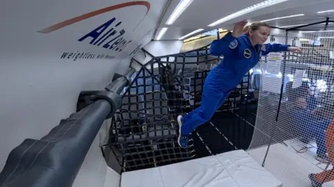 ESA/Novespace Dr Meganne Christian, an ESA reserve astronaut, floats to the top of the inside of a plane. 