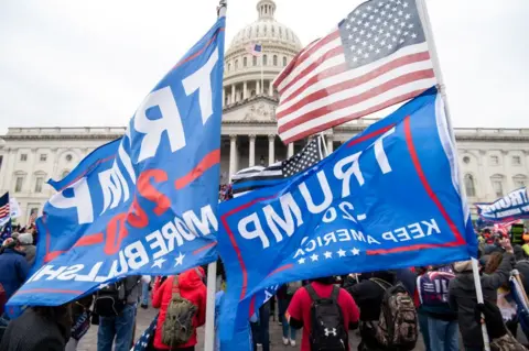 Getty Images Huge, blue pro-Trump flags are being held in front of the US Capitol on January 6 in 2001 as his supporters headed to Congress and subsequently breached the walls.