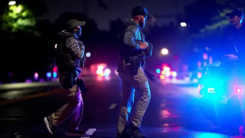 Getty Images Law enforcement officers respond following reports of gunfire near the White House in Washington, DC, US, on Saturday, May 23, 2026. 