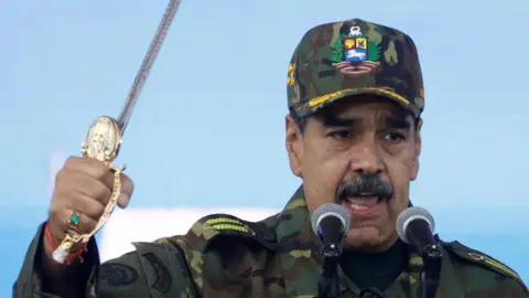 Reuters Venezuela's President Nicolas Maduro holds Simon Bolivar's sword as he addresses members of the armed forces
