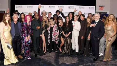 Getty Images (L-R) Madison Cunningham, Terry Britten, Jimmy Jam, Kylie Cantrall, Dallas Austin, Tricky Stewart, Gavin DeGraw, Taylor Dayne, Kenny Loggins, Linda Moran, Nile Rodgers, sombr, Taylor Swift, Alanis Morissette, Paul Stanley, Brandi Carlile, Billy Corgan, John Fogerty, Jane Seymour, Steve Miller, Steve Miller, Chauntee Ross, Monique Ross and Sheléa at the Songwriters Hall Of Fame ceremony