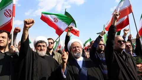 Getty Images A crowd at the funeral of Alireza Tangsiri, commander of the Iranian Revolutionary Guard Corps' navy, in Tehran on 1 April.