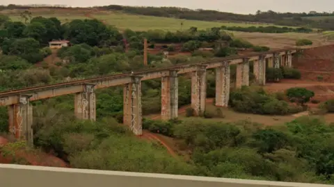 Google A landscape view of the abandoned bridge in Ponte do Esqueleto with fields surrounded the infastructure
