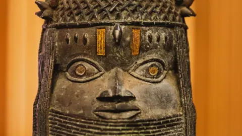 Getty Images A Benin Bronze is pictured in Abuja during the restitution ceremony of the Benin Bronzes to Nigeria - 20 December 2022 