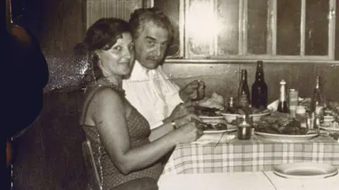 Robert Nickelsberg / Getty Images A black and white image of a man and woman eating