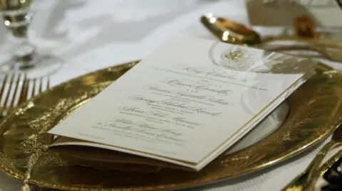 Reuters A menu and place setting during a state dinner for Britain's King Charles and Queen Camilla at the White House in Washington, D.C., U.S., April 28, 2026. REUTERS/Evelyn Hockstein

