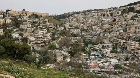 AFP File photo showing homes in the the al-Bustan area of Silwan, in Israeli-occupied East Jerusalem, in a valley below the al-Aqsa mosque compound (15 April 2026)
