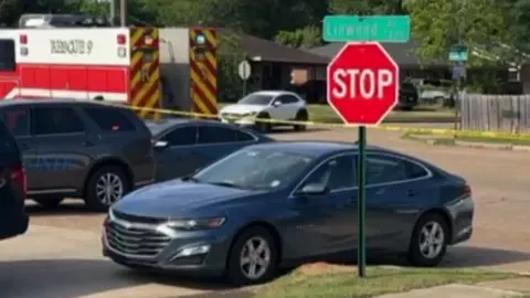 Shreveport Police Department Cars and a police tape at the scene of a shooting in Louisiana