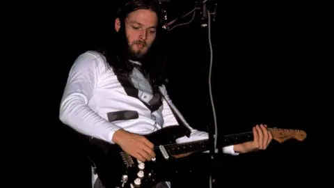 Richard E. Aaron/Redferns via Getty Images A 1975 image of Gilmour playing the guitar