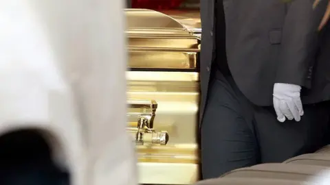 Ulises Ruiz/AFP via Getty Image A funeral employee carries the coffin of drug trafficker Nemesio "El Mencho" Oseguera at La Paz funeral home in Guadalajara, Jalisco state, Mexico, on March 2,
