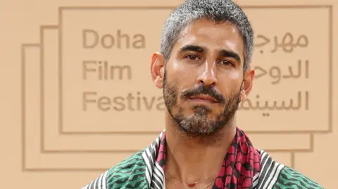 Getty Images File photo showing Ahmed Shihab-Eldin at the Doha Film Festival 2025 in Doha, Qatar (24 November 2025). He has short brown hair and a short brown beard.