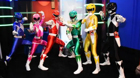 Getty Images Actors dressed as Power Rangers pose at a comic book event in the US