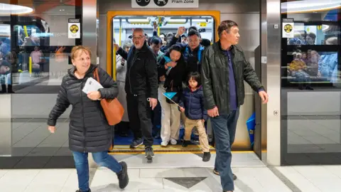 Getty Images Commuters disembark a train at Anzac station on Melbourne’s Metro line.