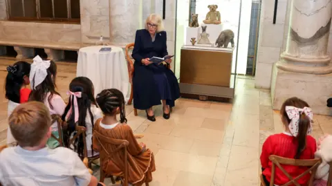 PA Media Queen Camilla reads Winnie-the-Pooh to children during a visit to the New York Public Library to celebrate literature.